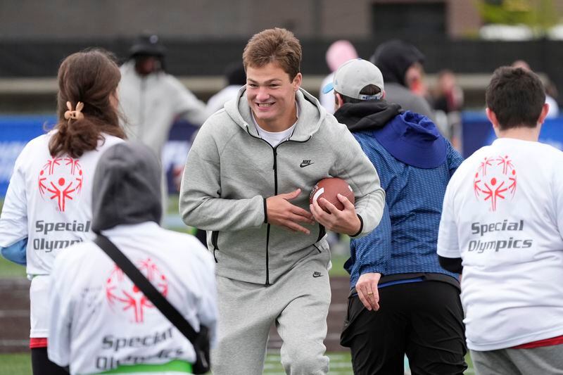 North Caroline quarterback Drake Maye works with young athletes during an NFL Football Play Football Prospect Clinic with Special Olympics athletes, Wednesday, April 24, 2024 in Detroit. (AP Photo/Carlos Osorio)