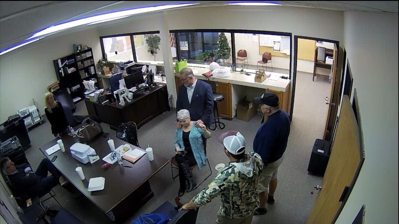 Surveillance video of the Coffee County elections office shows bail bondsman Scott Hall giving county Republican Party Chairwoman Cathy Latham a massage on the day that tech experts copied confidential voting data on Jan. 7, 2021. Also pictured are Paul Maggio and Jennifer Jackson of SullivanStrickler, county elections board member Eric Chaney and an unidentified man. Source: Coffee County