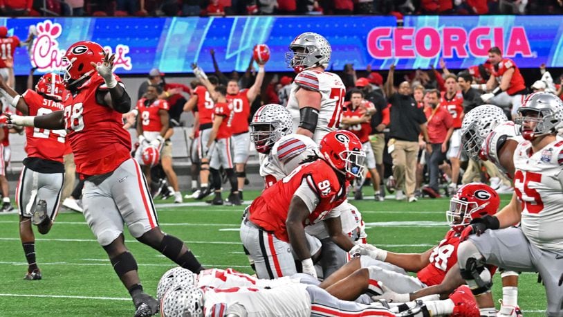 Georgia players and coaching staff celebrate after Ohio State's place kicker Noah Ruggles (95) failed to score the field goal at the end of the fourth quarter in the 2022 CFP Semifinal at the Chick-fil-A Peach Bowl Saturday, Dec. 31, 2022, in Atlanta. Georgia won 42-41 over Ohio State. (Hyosub Shin / Hyosub.Shin@ajc.com)
