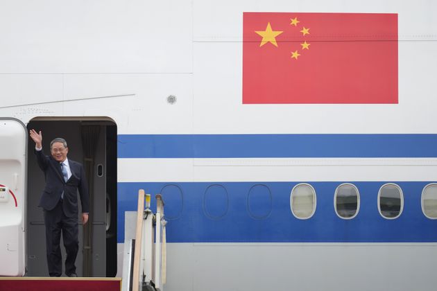 Chinese Premier Li Qiang waves as he arrives for a trilateral meeting at the Seoul airport in Seongnam, South Korea, Sunday, May 26, 2024. Leaders of South Korea, China and Japan will meet next week in Seoul for their first trilateral talks since 2019. (AP Photo/Lee Jin-man)