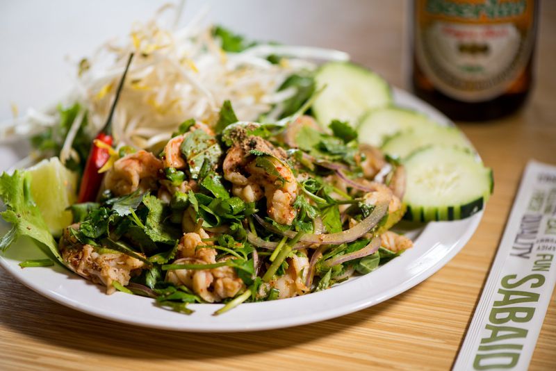  Nam Khao, crispy coconut rice salad with cured pork or tofu. Photo credit- Mia Yakel.