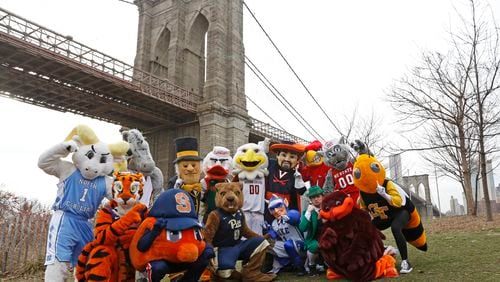 All 15 ACC mascots pose for a group photograph on Monday, March 6, 2017, beneath the Brooklyn Bridge. The mascots were promoting the ACC basketball tournament March 7-11 at the Barclays Center in Brooklyn. (AP Photo/Kathy Willens)