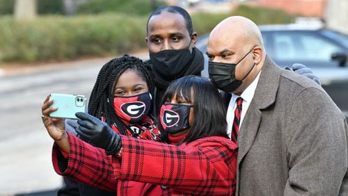 January 9, 20201 Athens - Ericka Davis (center) holds her iPhone to take a photograph with (clockwise from left), Shontel Cargill, Jeff Brown and Hamilton Holmes Jr. after they rang the Chapel Bell to honor the 60th anniversary of desegregation of the University of Georgia outside the UGA Chapel on the campus in Athens on Saturday, January 9, 2021. On January 9, 1961, two courageous students, Hamilton Holmes and Charlayne Hunter, took heroic steps on the University of GeorgiaÕs campus to enroll as students followed by Mary Frances Early, who entered graduate school that summer. Their legacies continue as they have contributed a lifetime of public service to their communities. Because of these students, the university now boasts a diverse campus made of numerous nationalities, races and ethnicities. (Hyosub Shin / Hyosub.Shin@ajc.com)