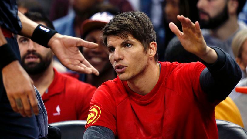 Kyle Korver cheers on Hawks players from the bench after news of his trade to Cleveland broke.
