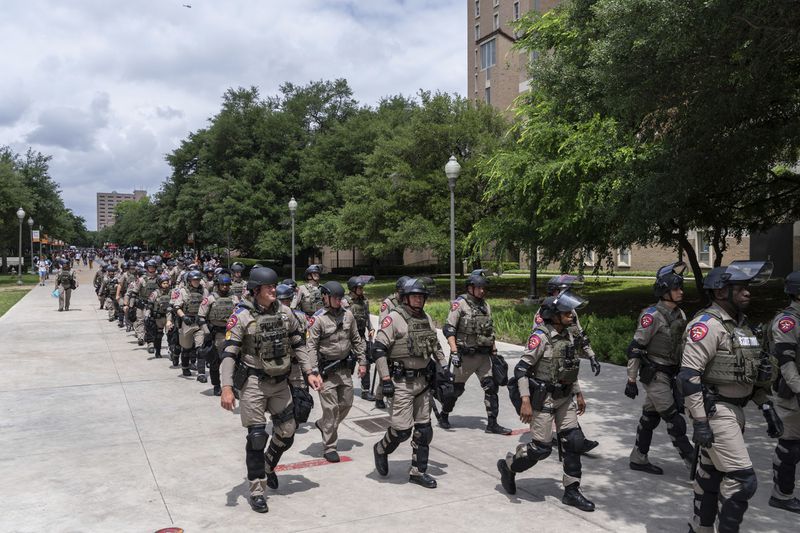 Texas state troopers march down Speedway during a pro-Palestinian protest at the University of Texas, Wednesday, April 24, 2024, in Austin, Texas. (Mikala Compton/Austin American-Statesman via AP)