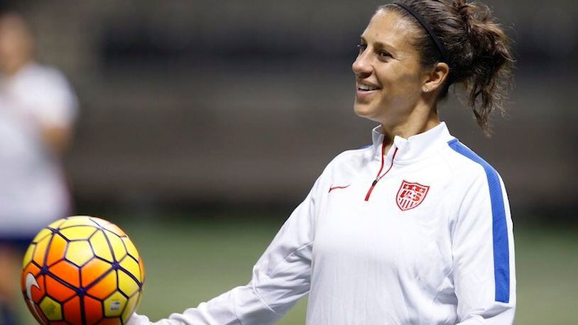FILE - In this Dec. 15, 2015, file photo, U.S. midfielder Carli Lloyd smiles during a practice session for the team's international soccer friendly against China in New Orleans. Lloyd and defender Becky Sauerbrunn have been chosen captains of the U.S. Women's National Team. (AP Photo/Gerald Herbert, File)