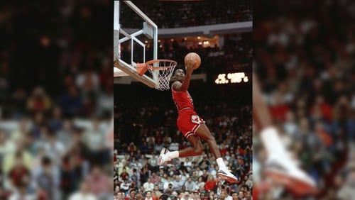 FILE - In this Feb. 6, 1988, file photo, Chicago Bulls' Michael Jordan dunks during the slam-dunk competition of the NBA All-Star weekend in Chicago. (AP Photo/John Swart)