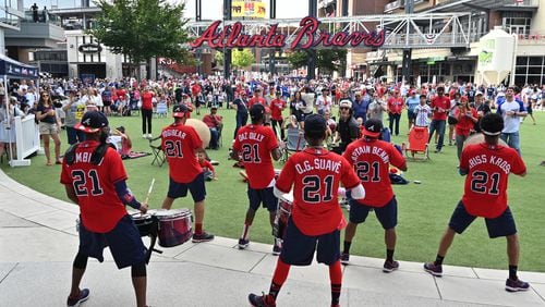 Getting fired up for Game 4: The Heavy Hitters drumline entertains baseball fans at The Battery Atlanta Tuesday prior to Game 4 of the National League Divisional Series between the Braves and Brewers.