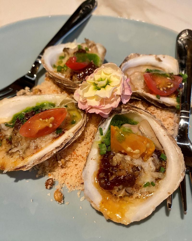 Falling Rabbit’s grilled oysters are dotted with fig and tomato jam, gooseberries and garlic butter. (Wendell Brock for The Atlanta Journal-Constitution)