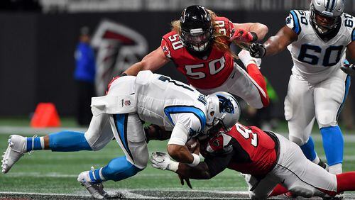 Falcons defensive end Brooks Reed (50) flies to the aid of defensive tackle Grady Jarrett (97) as Carolina Panthers quarterback Cam Newton (1) is brought down during the first half Sunday December 31, 2017. Photo by Brant Sanderlin/AJC file