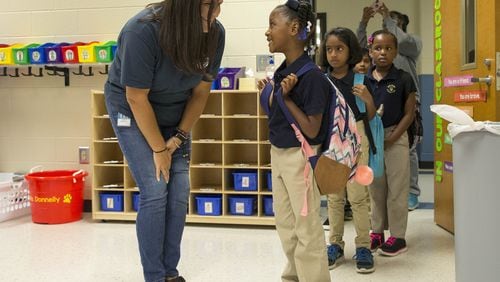 Second grade teacher Megan Donnelly greets Aniya Bowden during the first day of school at Brumby Elementary School in Marietta last month. A House member says Georgia must do more to attract and keep teachers in the classroom.