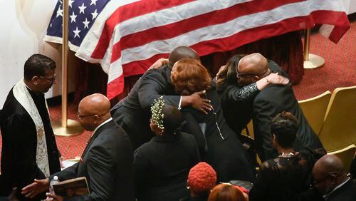 Family members are hugged by clergy during a memorial service for CDC researcher Timothy Cunningham, who was pulled from the Chattahoochee River after being missing for seven weeks, held Saturday at Morehouse April 21, 2018.
