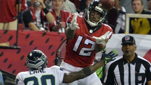 January 14, 2017 Atlanta - Atlanta Falcons wide receiver Mohamed Sanu (12) catches a touchdown pass over Seattle Seahawks cornerback Jeremy Lane (20) in the second half during the NFC divisional playoffs at the Georgia Dome on Saturday, January 14, 2017. Atlanta Falcons won 36-20 over the Seattle Seahawks. HYOSUB SHIN / HSHIN@AJC.COM