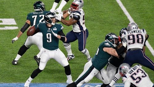 The Eagles’ Nick Foles  looks to pass against the  Patriots during the second quarter of Super Bowl LII at U.S. Bank Stadium.