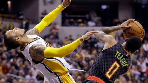 Atlanta Hawks' Jeff Teague (0) is called for a charging foul against Indiana Pacers' Monta Ellis, left, during the second half of an NBA basketball game Thursday, Jan. 28, 2016, in Indianapolis. Indiana won 111-92. (AP Photo/Darron Cummings)