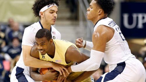 Georgia Tech guard Curtis Haywood II (13) tries to escape the defense of Pittsburgh's Parker Stewart (1) and Shamiel Stevenson (23) during the first half of an NCAA college basketball game, Saturday, Jan. 13, 2018, in Pittsburgh. (AP Photo/Jared Wickerham)