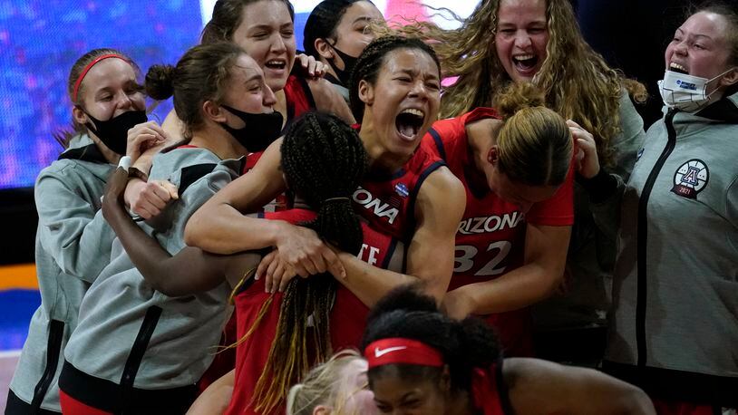 Arizona players celebrate after a women's Final Four NCAA college basketball tournament semifinal game against Connecticut Friday, April 2, 2021, at the Alamodome in San Antonio. Arizona won 69-59. (AP Photo/Eric Gay)