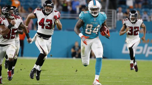 Miami Dolphins wide receiver Damore'ea Stringfellow (84) runs for a touchdown ahead of Atlanta Falcons linebacker Jack Lynn (43), cornerback Jalen Collins (32) and defensive back Marcelis Branch (35), during the second half of an NFL preseason football game, Thursday, Aug. 10, 2017, in Miami Gardens, Fla. (AP Photo/Wilfredo Lee)