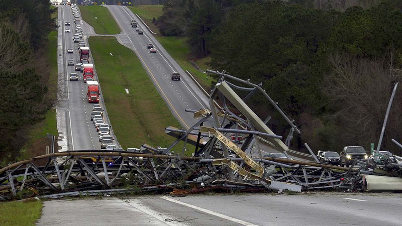 A fallen cell tower lies across U.S. Route 280 highway in Lee County, Ala., in the Smiths Station community after what appeared to be a tornado struck in the area Sunday, March 3, 2019. Severe storms destroyed mobile homes, snapped trees and left a trail of destruction amid weather warnings extending into Georgia, Florida and South Carolina, authorities said.
