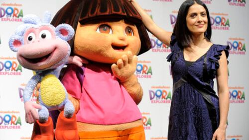 SHE SURE IS GROWING UP: Salma Hayek measures Dora the Explorer, who held her sidekick Boots the Monkey, during an event to announce plans for the 10th anniversary of the animated television series at Nickelodeon Animation Studio in Burbank, Calif.