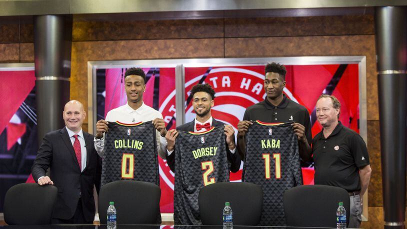 Atlanta Hawks General Manager, Travis Schlenk (far left), and Head Coach Mike Budenholzer (far right), stand on the outside of rookies: John Collins (left), Tyler Dorsey (middle) and Alpha Kaba (right). Chad Rhym/ Chad.Rhym@ajc.com