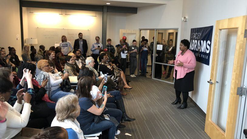 Democrat Stacey Abrams thanks dozens of volunteers working in her campaign for governor. Abrams has veered from a traditional strategy of hoarding cash until closer to the May 22 primary in order to build a get-out-the-vote effort now.