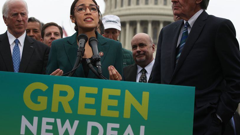 Rep. Alexandria Ocasio-Cortez (D-N.Y.) speaks as Sen. Ed Markey (D-Mass.), right, and other Congressional Democrats listen during a news conference in front of the U.S. Capitol on Thursday, Feb. 7, 2019, in Washington, DC. **FOR USE WITH THIS STORY ONLY**(Alex Wong/Getty Images/TNS)