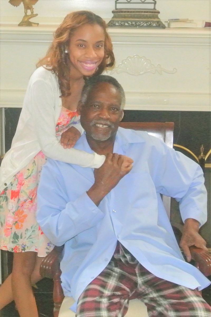 Marriah N. Paige shares a happy moment with her grandfather Fred Paige at their home in Lithonia before his death in 2015. CONTRIBUTED