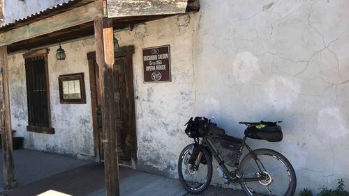 Mark Finley parks his mountain bike at the Historic Buckhorn Saloon in Pinos Altos, New Mexico, as he rides a segment of the 2,750-mile Great Divide Mountain Bike Route. (PHOTO COURTESY OF MARK FINLEY)