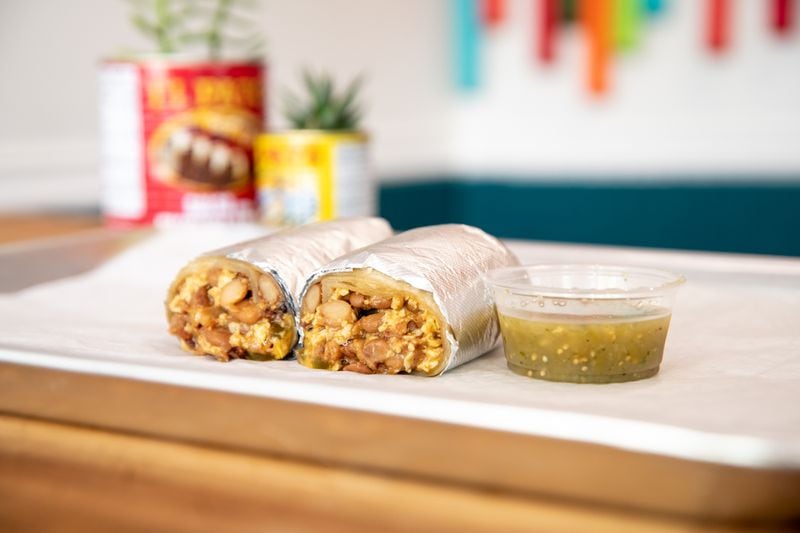 Poco Loco Burrito is made with Pine Street Market bacon, Moore's Farm eggs, sweet pickled jalapenos, yellow cheese, house-made flour tortilla, and salsa verde. Mia Yakel for The AJC