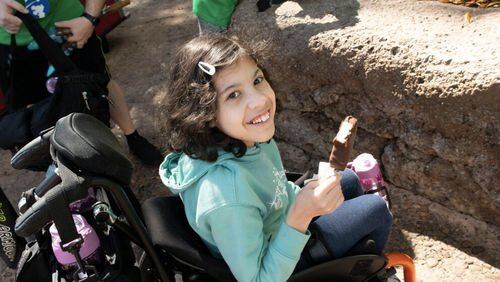 Eliora B. eating ice cream while she waits in line for an attraction at Disney World. (Photo courtesy of Bert's Big Adventure)