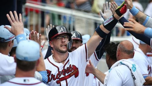 Tyler Flowers gets high fives in the dugout after hitting a 2-RBI home run to take a 4-1 lead over the San Diego Padres during the eighth inning in a MLB baseball game on Sunday, June 17, 2018, in Atlanta.  Curtis Compton/ccompton@ajc.com