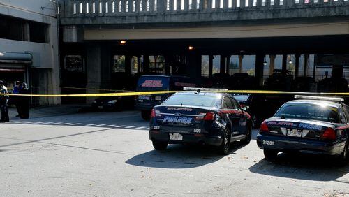 Atlanta police investigate a suspicious death in a parking garage adjacent to the Georgia State campus Friday, November 14, 2014. KENT D. JOHNSON/KDJOHNSON@AJC.COM