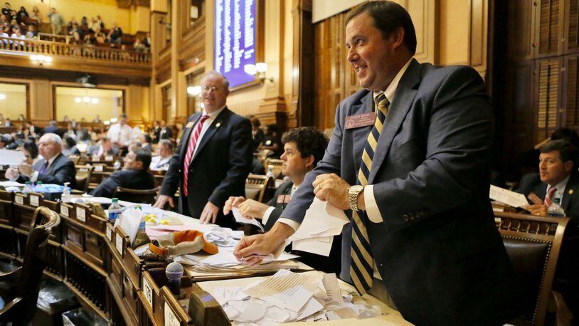 State Rep. Jason Shaw, R-Lakeland, tears up paper to throw when the final gavel fell on the 2017 General Assembly session Friday morning. The photo was taken shortly after the Senate gave final approval to Shaw’s Georgia Agribusiness and Rural Jobs Act. BOB ANDRES /BANDRES@AJC.COM