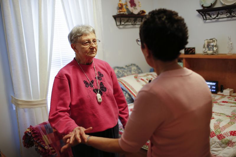 FILE - Martha Hays, left, works with nurse Sandy Miller, right, during a balance evaluation at the Hays home in Columbus, Ohio, July 19, 2017. As President Joe Biden runs for reelection, he's resurrecting proposals to reshape American life from the cradle to the grave by lowering the cost of child care, expanding preschool opportunities and raising pay for those who care for the elderly. (Joshua A. Bickel/The Columbus Dispatch via AP, File)