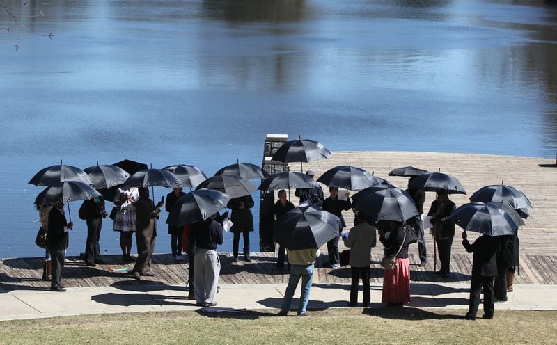 Organizers hold up black umbrellas in Atlanta on March 3, 2017, during a commemoration of the 158th anniversary of the largest sale of human beings in U.S. history. On March 2, 1859, 436 people were sold at an auction in Savannah. It is called “The Weeping Time” because reports note that the rain continued over the two days the auction happened and only stopped after the last slave walked off the stage. 