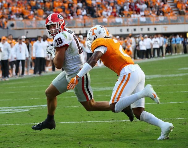 Georgia tight end Brock Bowers gets into the endzone past Tennessee defensive back Jaylen McCollough to take a 24-7 lead during the second quarter in a NCAA college football game on Saturday, Nov. 18, 2023, in Knoxville.  Curtis Compton for the Atlanta Journal Constitution