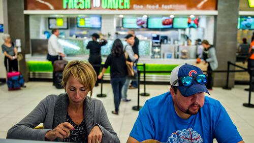 September 2, 2015 Atlanta - Hillary Mantel (left) and her husband James eat at the Terminal B food court inside the Hartsfield Jackson Atlanta International Airport on Wednesday, September 2, 2015. Restaurants inside the airport have challenges including limited space, tethered knives, mandatory knife inventory inspections and electric grills. JONATHAN PHILLIPS / SPECIAL