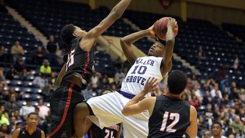 Naquante Hardy (10) of Miller Grove shoots against Allatoona defenders in the Class AAAAA boys championship at the Macon Coliseum on Friday, March 4, 2016. KENT D. JOHNSON/ kdjohnson@ajc.com