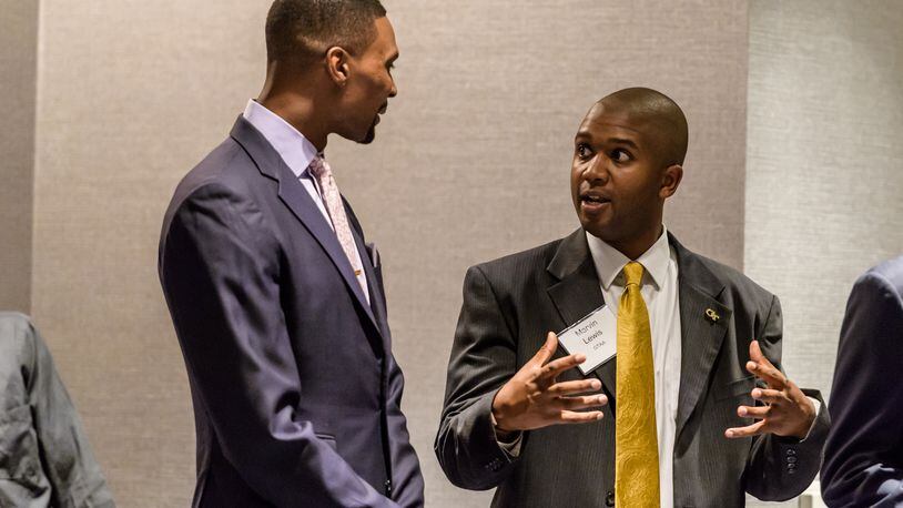 Georgia Tech senior associate Marvin Lewis (right) speaks with former Yellow Jackets basketball star Chris Bosh at the athletic department's hall of fame induction banquet in October 2016. (Danny Karnik/Georgia Tech Athletics)