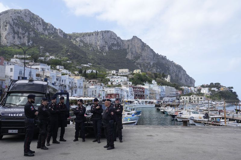 Italian Carabinieri paramilitary policemen gather at the Capri's harbour, Wednesday, April 17, 2024. Group of Seven foreign ministers are meeting on the Italian resort island of Capri, with soaring tensions in the Mideast and Russia's continuing war in Ukraine topping the agenda. The meeting runs April 17-19. (AP Photo/Gregorio Borgia)