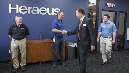 Gwinnett County principals and district leaders (right) are greeted by Heraeus employees (left) during a field trip to Heraeus in Buford, Thursday, June 13, 2019. For the third year, Gwinnett County Public Schools is partnering with area businesses to host its Principal Field Trip. This year, 60 school system leaders (high school and middle school principals, as well as a few district leaders) will participate, getting a firsthand look into the world of business and industry within Gwinnett County. ALYSSA POINTER/ALYSSA.POINTER@AJC.COM