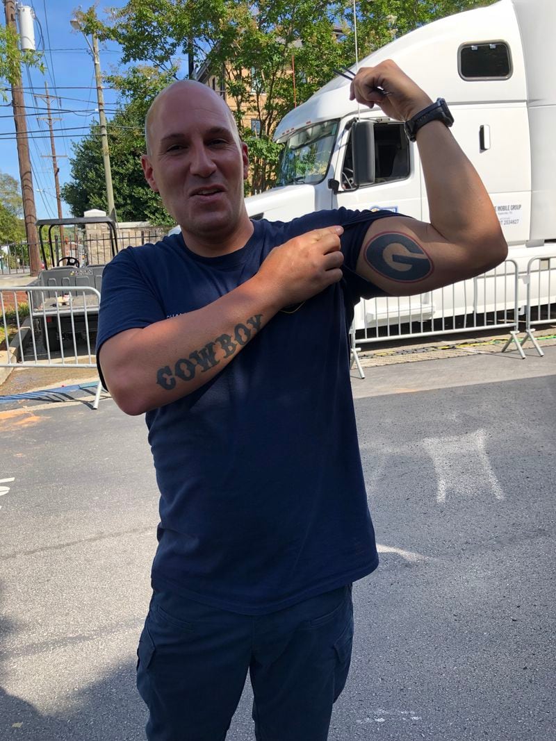 Nashville firefighter Justin Champion, who is originally from Brunswick, shows of the Georgia G tattoo on his left bicep. (Chip Towers/ctowers@ajc.com)