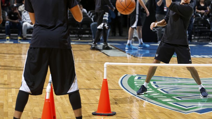 Minnesota Timberwolves vice president of sports performance Arnie Kander works with Ricky Rubio during warmups before a team scrimmage on Monday, Oct. 5, 2015, at the Target Center in Minneapolis. (Carlos Gonzalez/Minneapolis Star Tribune/TNS)