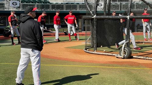 Georgia baseball coach Scott Stricklin and members of the 2022 baseball team watch sophomore Corey Collins take batting practice at Foley Field on Feb. 15 in Athens. (Photo by Chip Towers/ctowers@ajc.com)