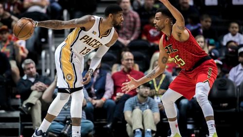 Indiana Pacers forward Paul George (13) controls the ball while defended by Atlanta Hawks forward Thabo Sefolosha (25) during the first quarter of an NBA basketball game, Sunday, March 5, 2017, in Atlanta. (AP Photo/Branden Camp)