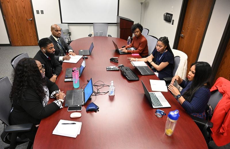 Dr. Natalie Hernandez (executive director), right, leads a meeting with her staff, clockwise from left, Shamonica McGill (research administrator), Aaron Brown (program manager), DeMorris Murry (project coordinator), Dr. Lasha Clarke (postdoctoral fellow) and Erin Harris (research assistant) at Morehouse School of Medicine’s Center for Maternal Health Equity, Wednesday, Jan. 25, 2023, in Atlanta. (Hyosub Shin / Hyosub.Shin@ajc.com)