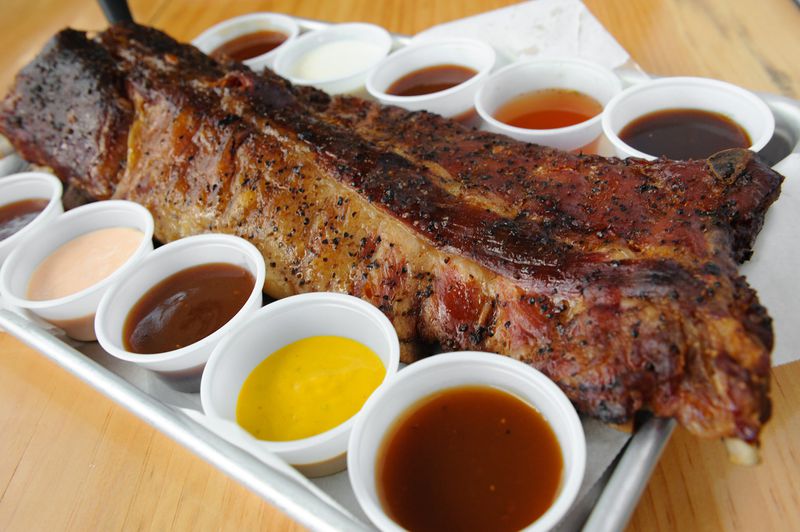 A full rack of Vic’s Ribs at the Nest with a sample of all 10 barbecue sauces. (Beckystein.com)