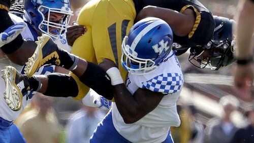 Kentucky safety Marcus McWilson plants Missouri quarterback Marvin Zanders during the Wildcats 35-21 victory Saturday. (AP Photo/Jeff Roberson)