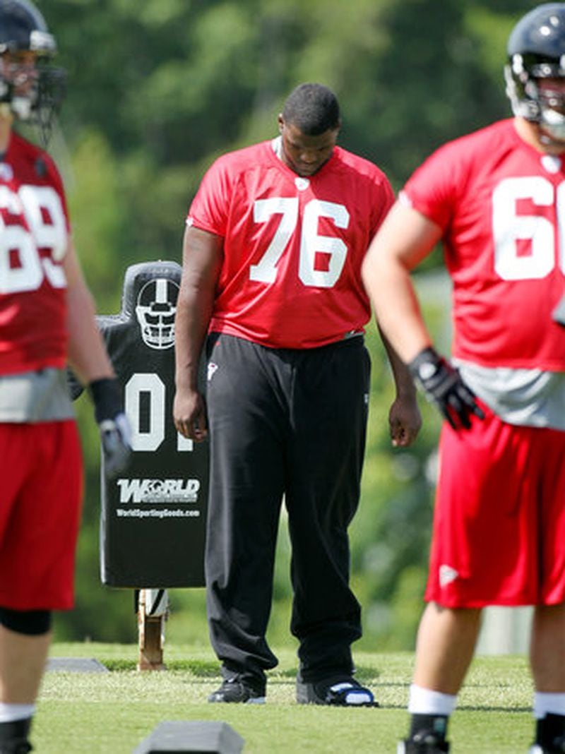 051112 FLOWERY BRANCH: Falcons offensive lineman Lamar Holmes stands on the sidelines with a boot on his foot the first day of practice with the team in Flowery Branch, Friday, May 11, 2012. CURTIS COMPTON / CCOMPTON@AJC.COM 051112 FLOWERY BRANCH: Falcons offensive lineman Lamar Holmes stands on the sidelines with a boot on his foot the first day of practice with the team in Flowery Branch, Friday, May 11, 2012. CURTIS COMPTON / CCOMPTON@AJC.COM
